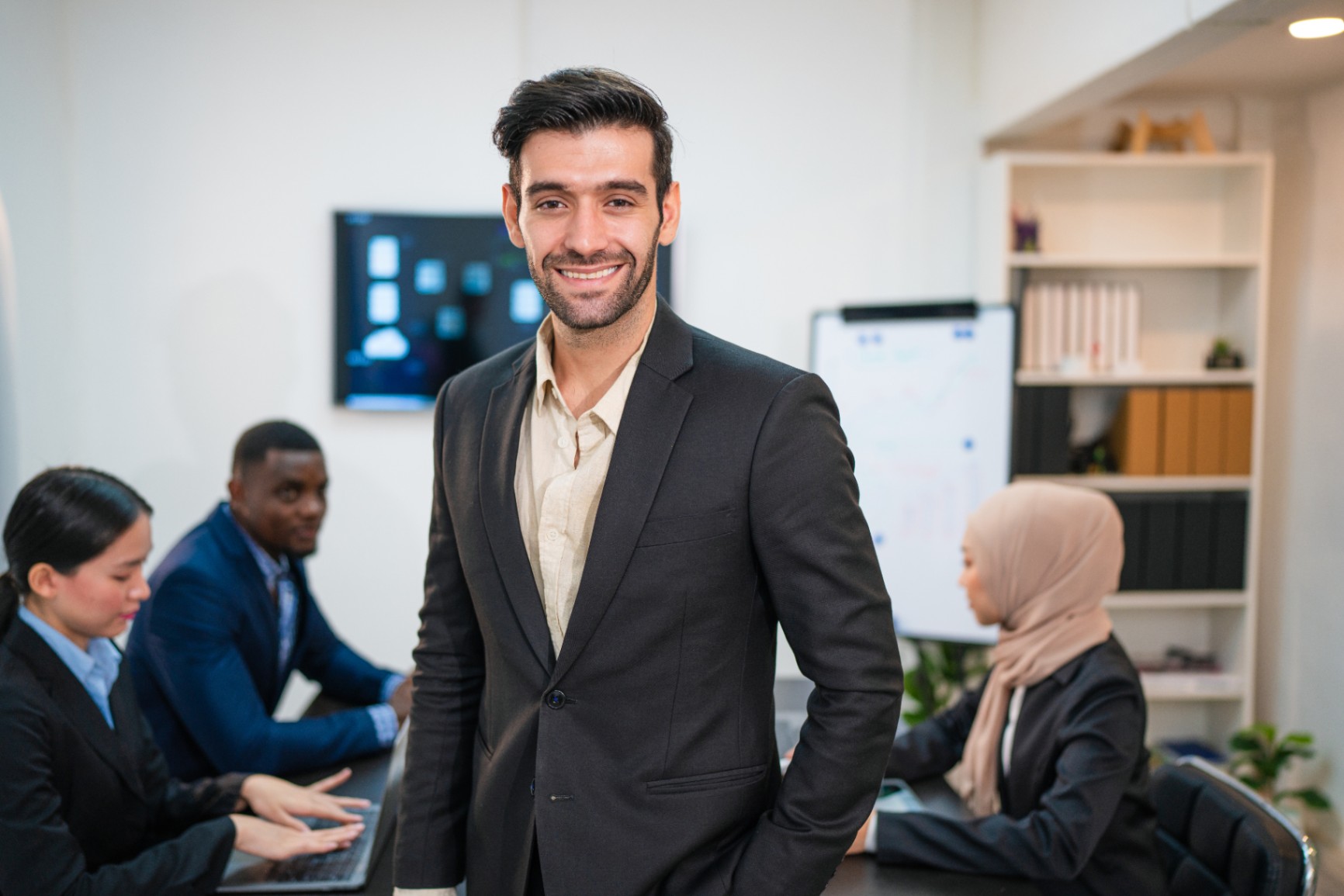 successful-businessman-working-and-looking-camera-6ZZDRKN